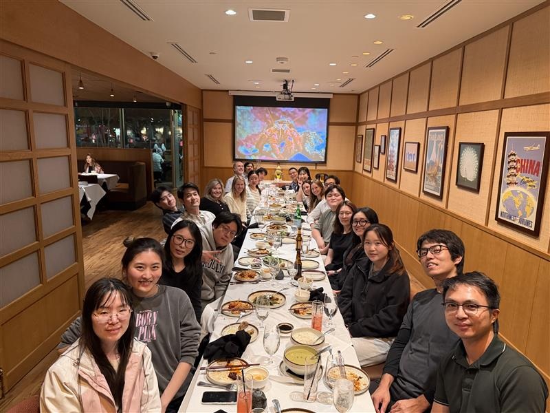 Choi Lab members seated together at a long dinner table.
