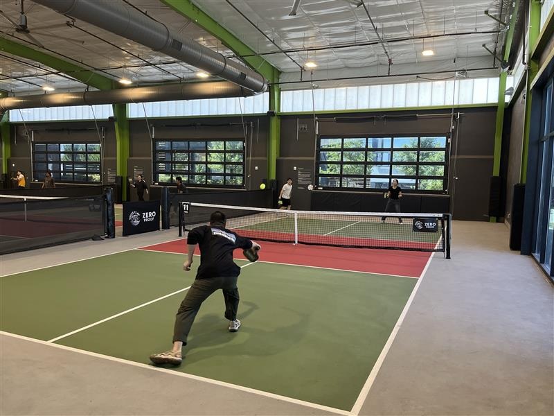 Choi Lab members playing pickleball on an indoor court.