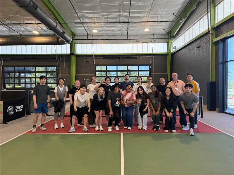 Choi Lab members posing together on an indoor pickleball court.