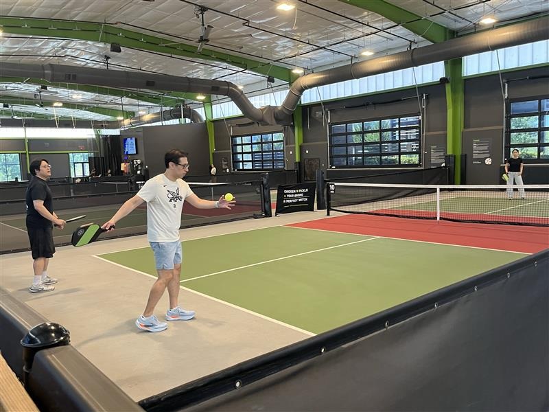 Choi Lab members playing pickleball indoors.
