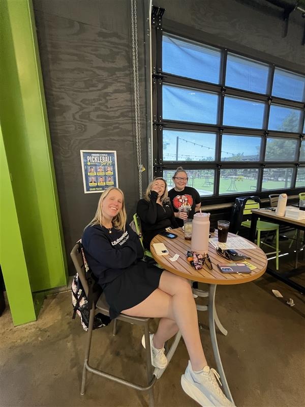 Choi Lab members seated together during a pickleball outing.