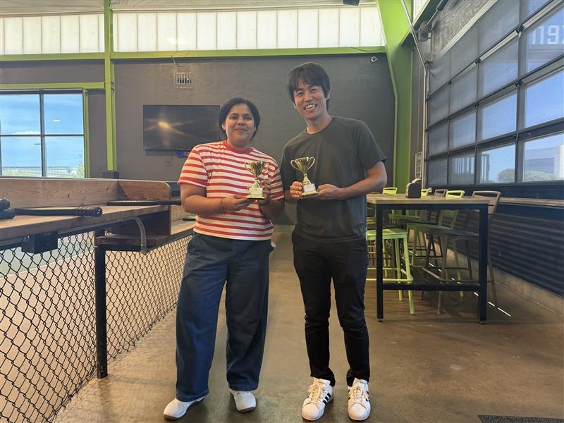 Two Choi Lab members holding trophies after a pickleball outing.